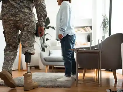 A person with a prosthetic leg walking through a home